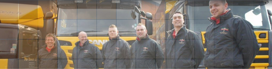Close up of work colleagues by lorries